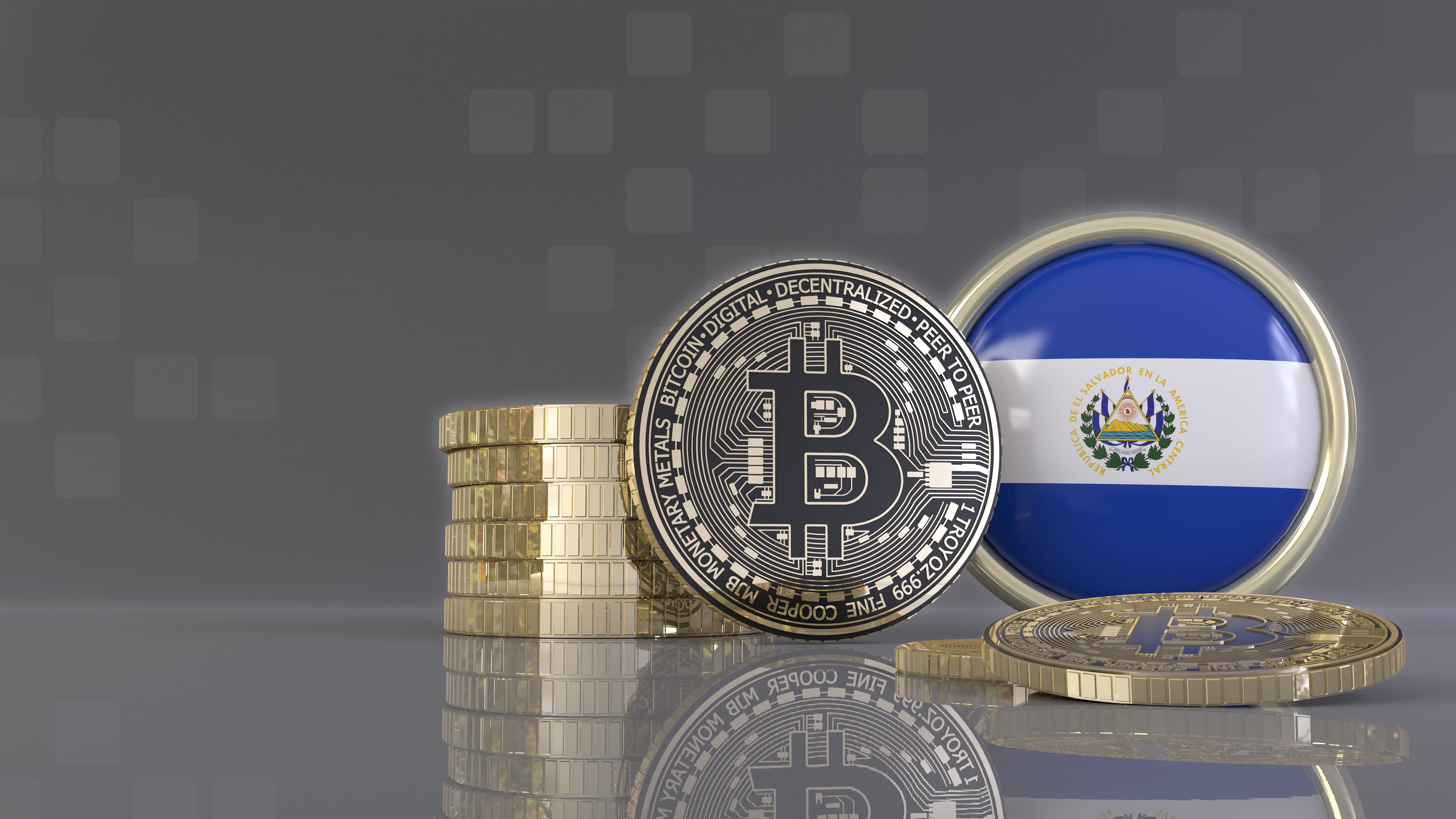 An artistic rendering of a bitcoin token in front of a badge with the flag of El Salvador.