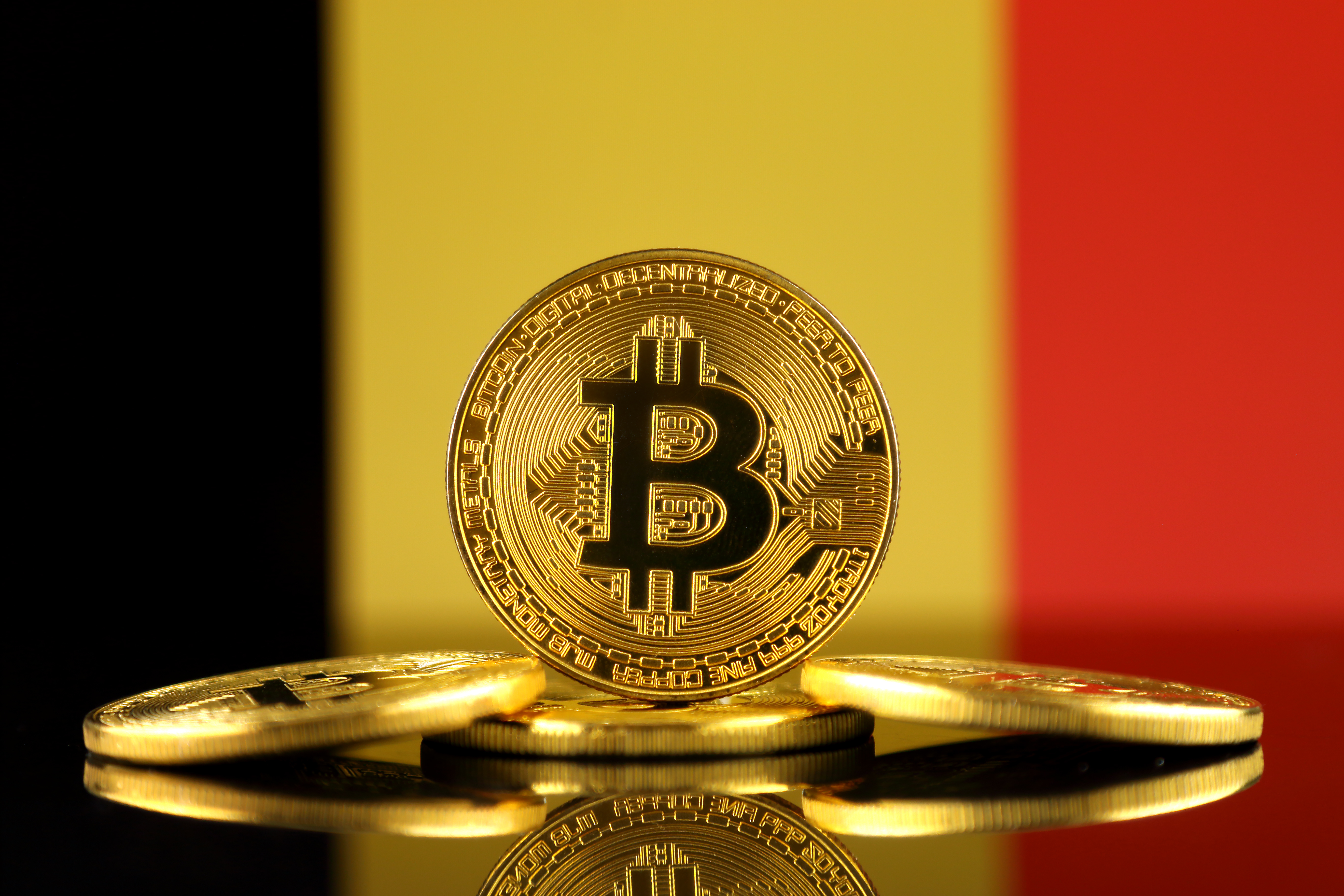 A representation of a stack of Bitcoin tokens against the backdrop of the Belgian flag.