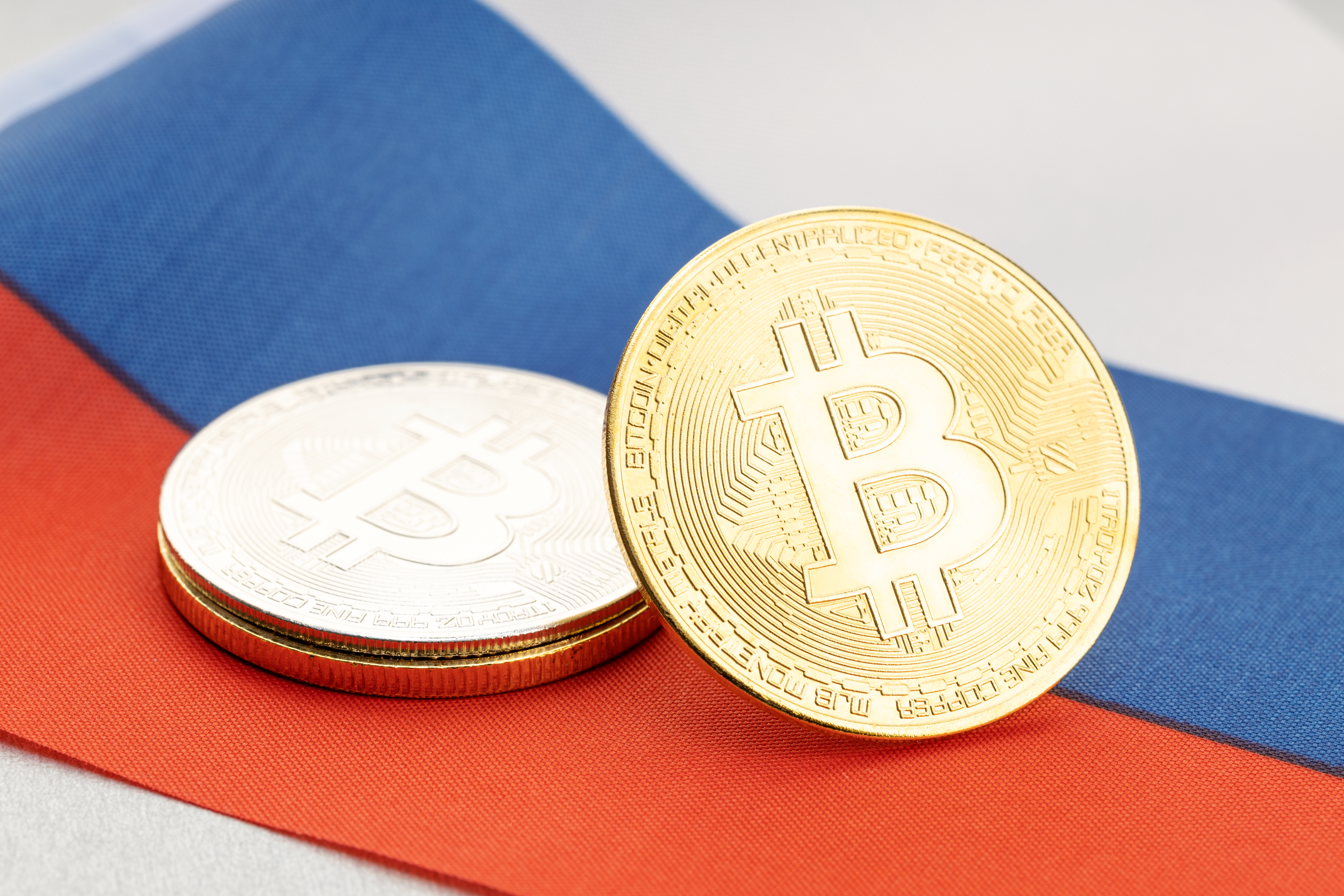 Tokens representing Bitcoin rest on the Russian national flag.