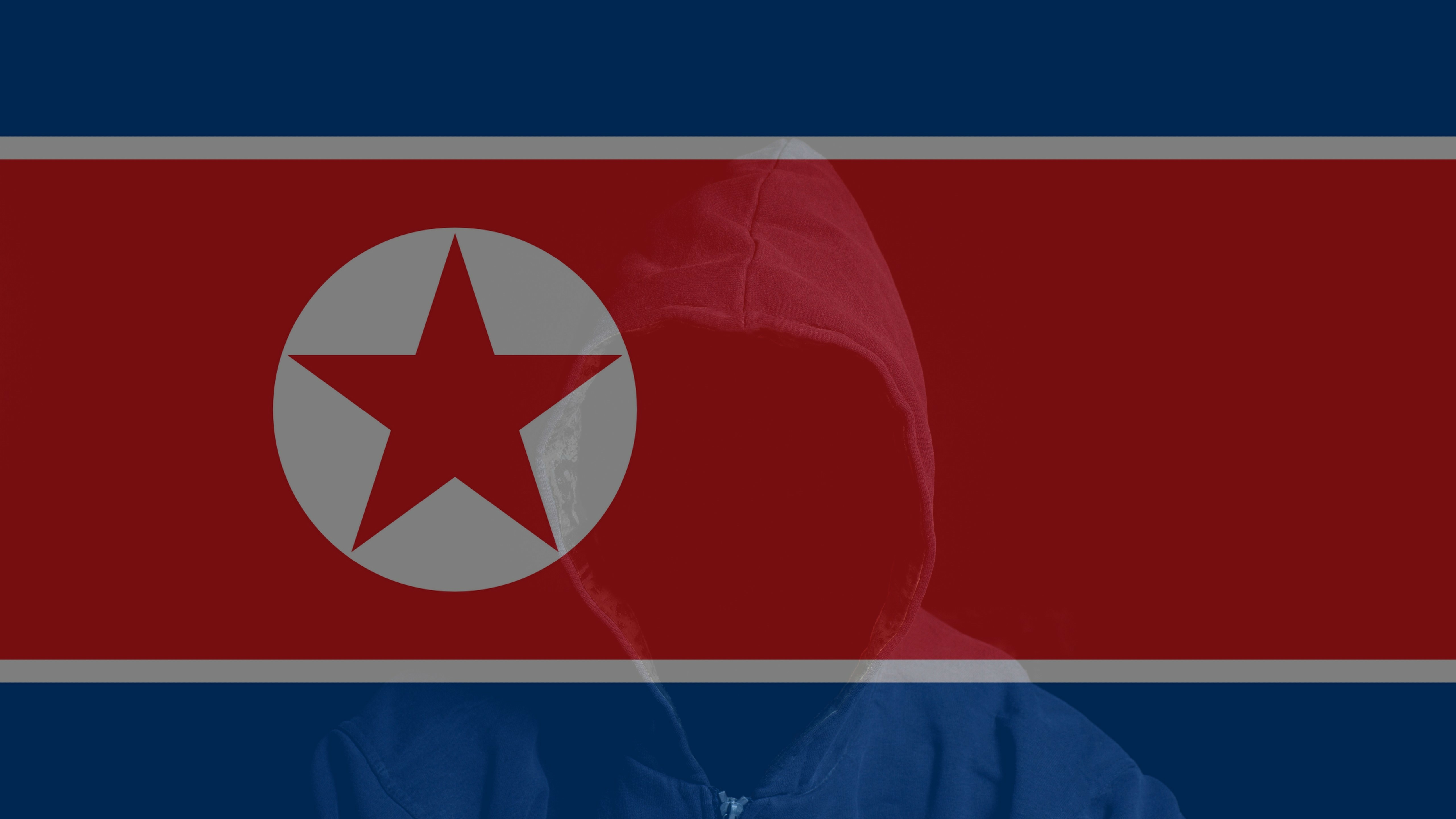 The North Korean flag with a hooded figure sitting in the foreground.