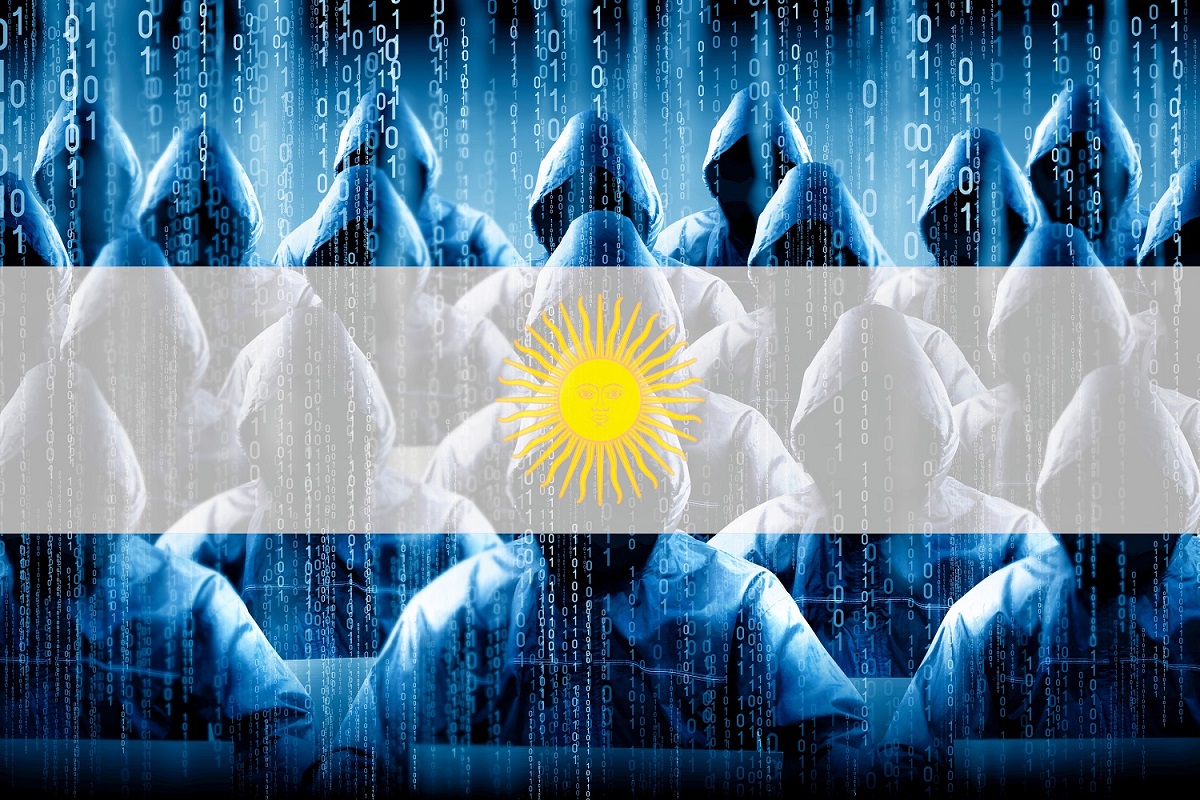 Những người trùm đầu ngồi ở các thiết bị đầu cuối máy tính với phông nền mã nhị phân, với Argentina cờ trong nền.